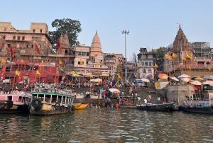boats on a river with temples in the background